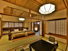 「温泉露天客室」のお部屋（美松亭）の一例。二間続きの和室にベッドがあり、源泉かけ流しの露天風呂付