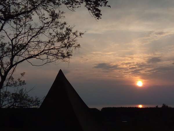 コテージ前広場から見た景色、日本海に浮かぶ佐渡島に夕日が沈みます