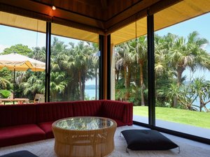 「琉球ヴィラ」のリビングルーム庭園と一体化した空間で景色を眺めながら、ゆったりとくつろぐことができます。