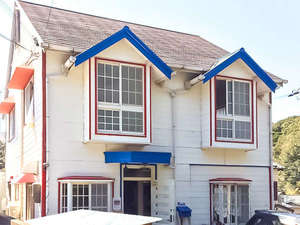 「ゲストハウス　白浜　Ｒｃａｆｅ」の・＜外観＞ホワイトを基調とした外装に赤と青のアクセントが印象的
