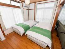 ベッドルームにシモンズのシングルベッドが2つ。枕は世界的に愛されているDanfillフィベールピローを使用