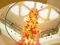 【ロビー】明るい天井から舞い落ちるような琉球ガラスの花びら(ブーゲンビリアの花びらをイメージ)