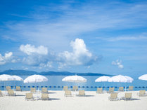 白いパラソル、白い砂浜、エメラルドグリーンの海のコントラストが美しいオクマビーチ。