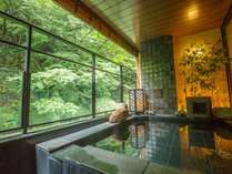 緑が間近に迫る最上階の温泉露天風呂。心地よい自然の声に耳を澄ましながら癒される。